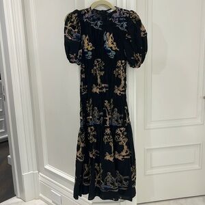 Fancy black dress with sewed design.